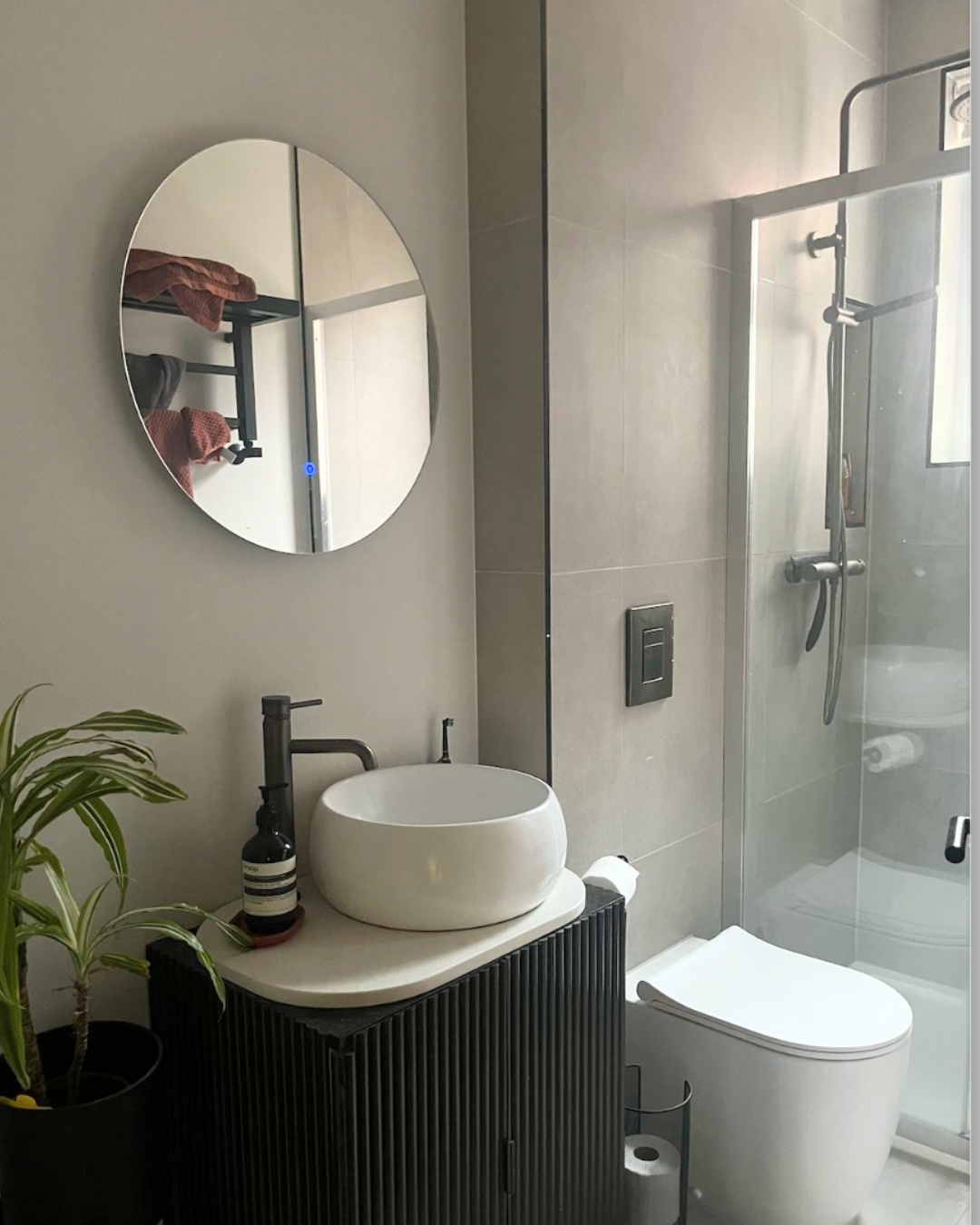 East Finchley renovation — styled living room corner with plants and tiled niche